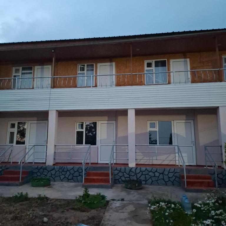 an image of a building with a balcony at Гостевой дом in Cholpon-Ata
