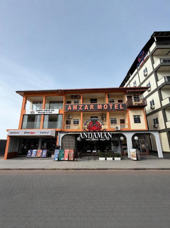 a building with a sign for an american motel at Amzar Motel Cenang in Pantai Cenang
