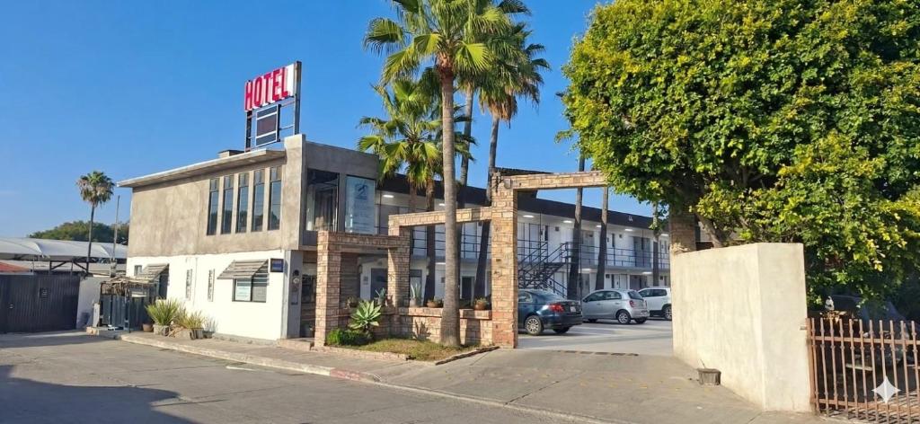 a building with a motel sign on top of it at Hotel Palmas Quintero in Rosarito Beach
