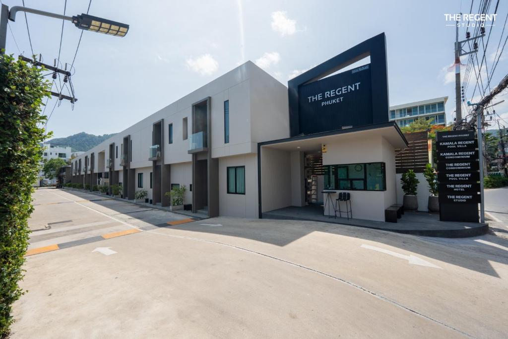 a building with a sign on the side of it at The Regent Studio Kamala in Kamala Beach