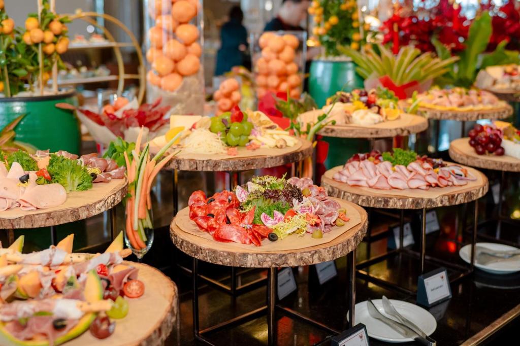 A lavish buffet display of cold cuts, fruit and prepared dishes.