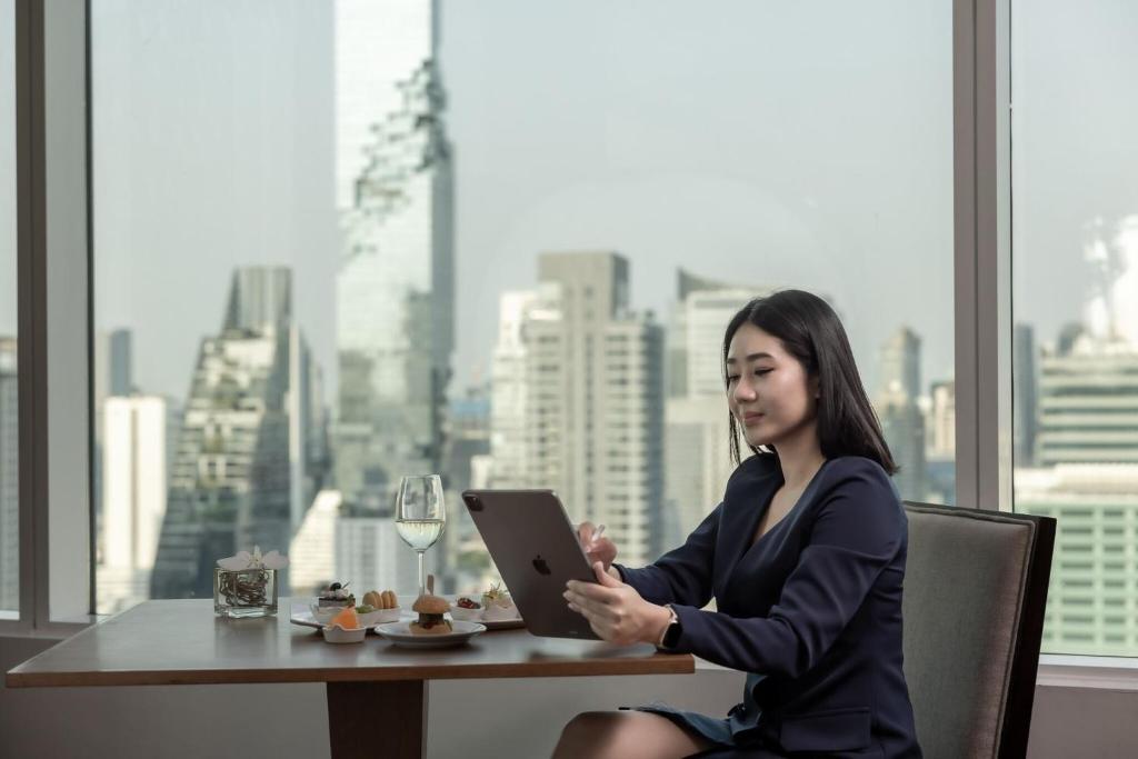 A window-side table provides a city view for tablet work or a light meal.