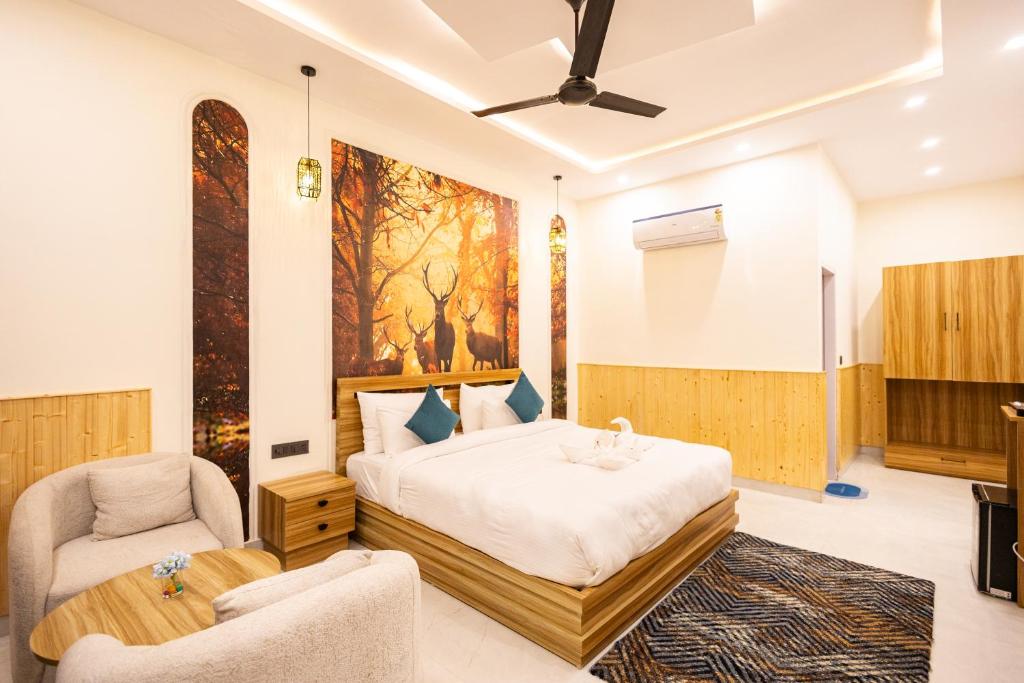 a bedroom with a king sized bed and a chair at Tiger Aura Resort in Rāmnagar
