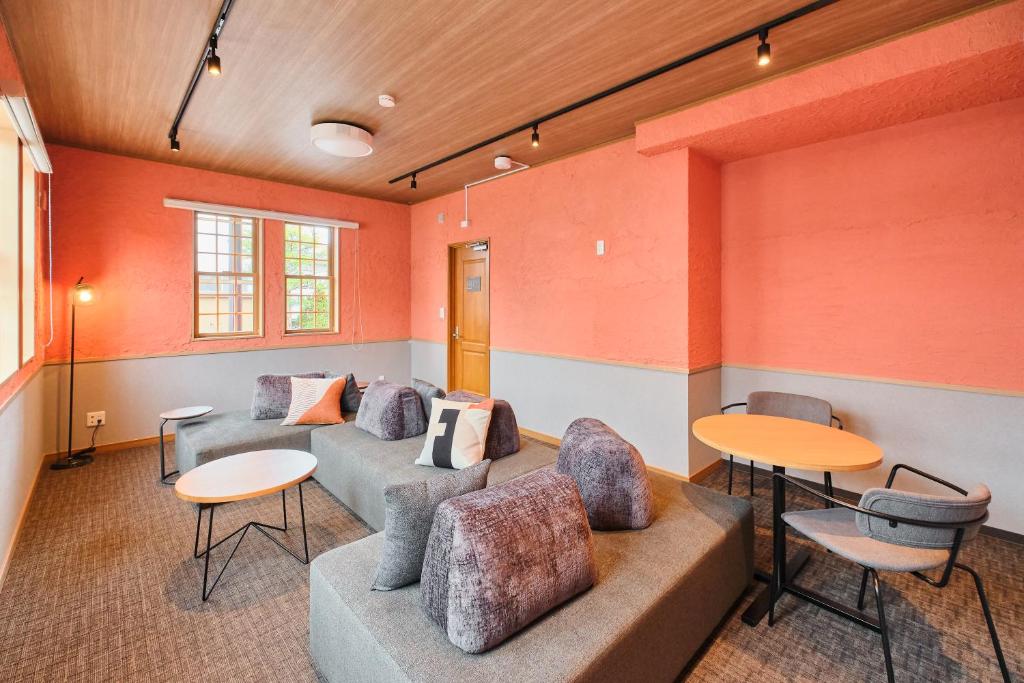 a waiting room with couches and tables at 星宿 Sirius in Asahikawa