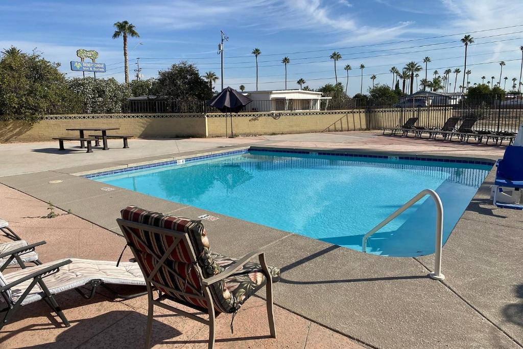a empty swimming pool with a chair and a picnic table at Budgetel Inn & Suites in Yuma
