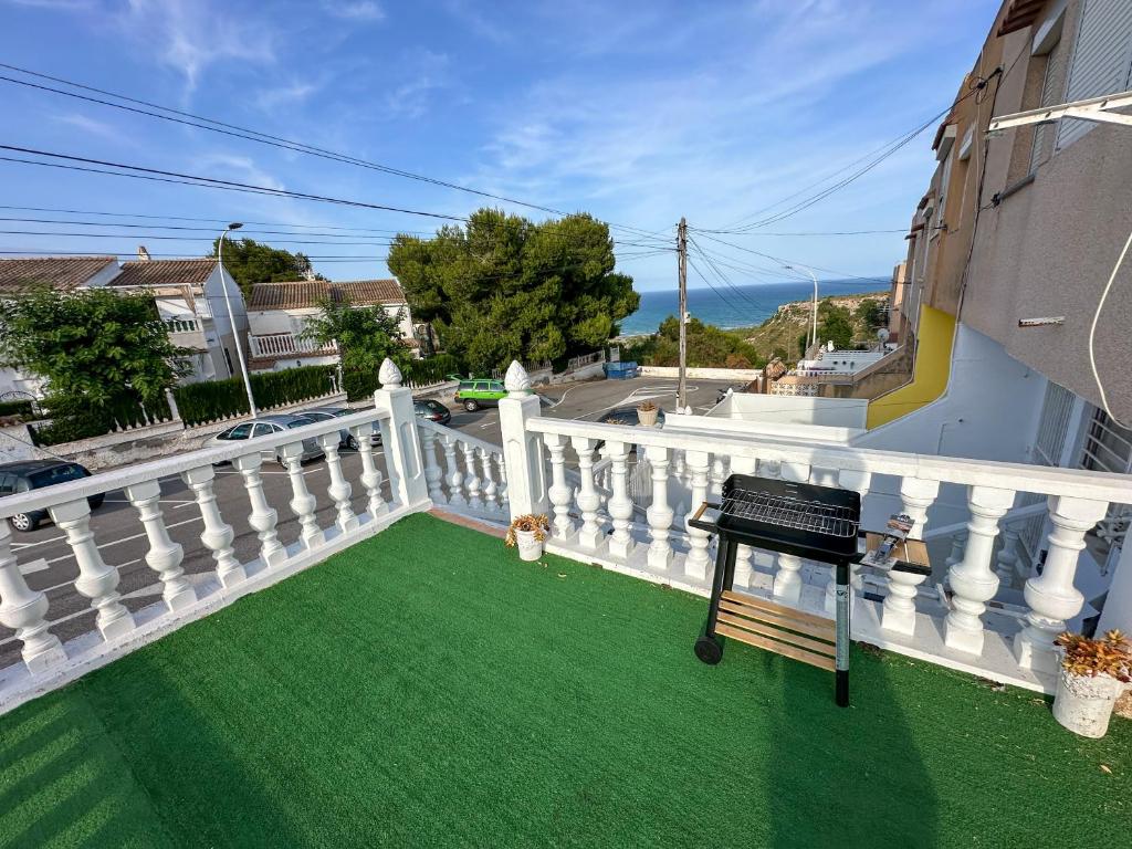 a balcony with green grass and a white railing at Bungalow and private XXL Terrace in Alicante