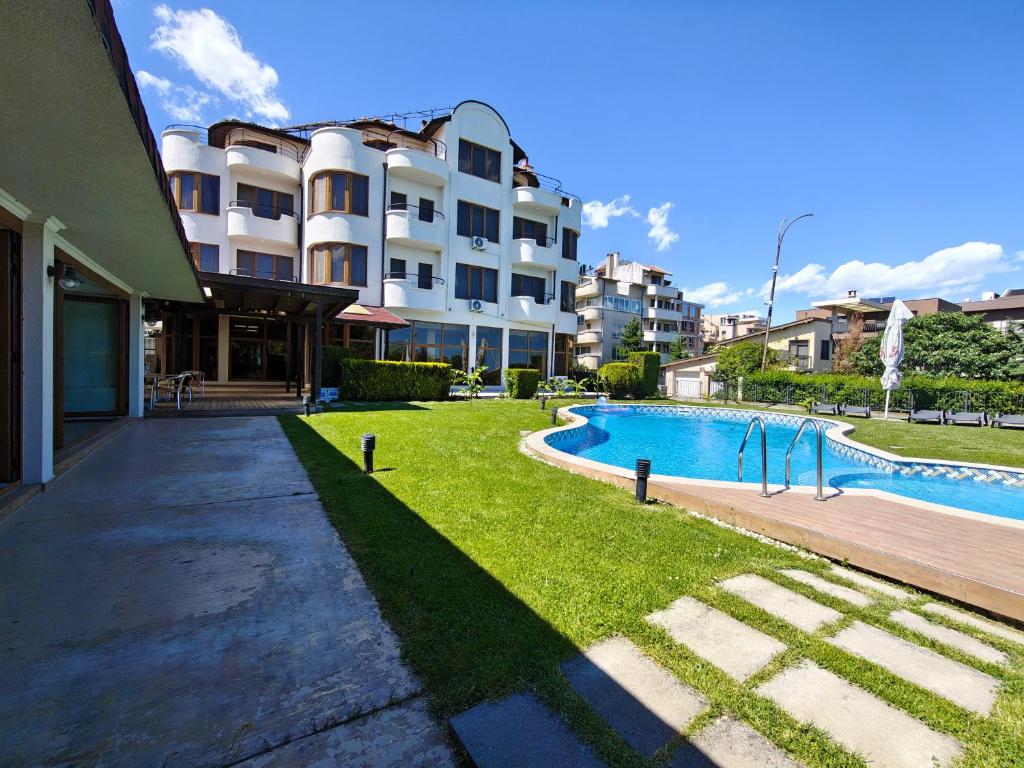 a swimming pool in front of a building at Семеен хотел"Свети Георги" in Burgas