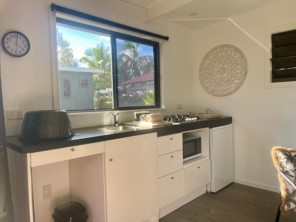 a kitchen with a sink and a window at Studio self-contained and recently renovated in Avarua