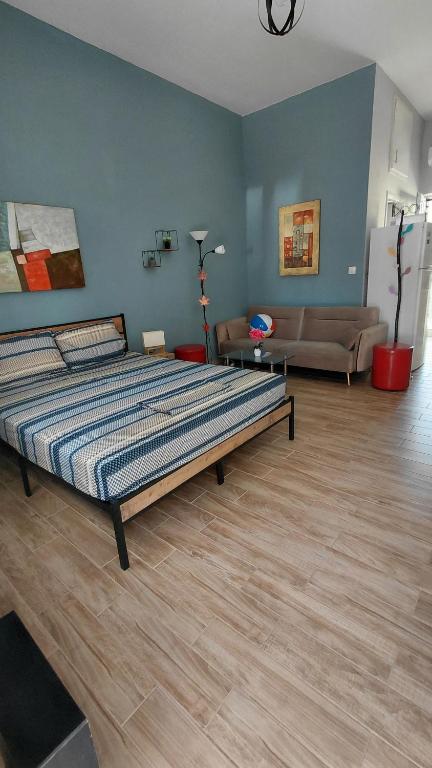 a bedroom with a bed and a living room at Victoria's dream in Filiatra