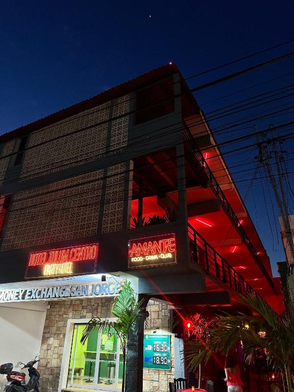 a building with neon signs on the side of it at Hotel Tulum Centro, Party Hotel in Tulum
