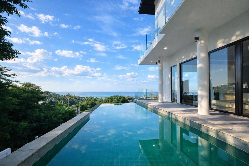 a swimming pool in a house with a view at Skyline Seaview Villa-5 Bedroom, 4 Bathrooms with Private Seaview Pool in Ban Thong Phlu