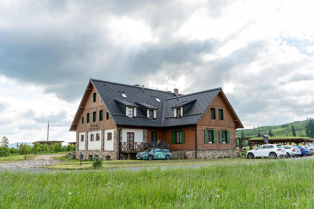 a large house with cars parked in front of it at Férovka in Jeseník