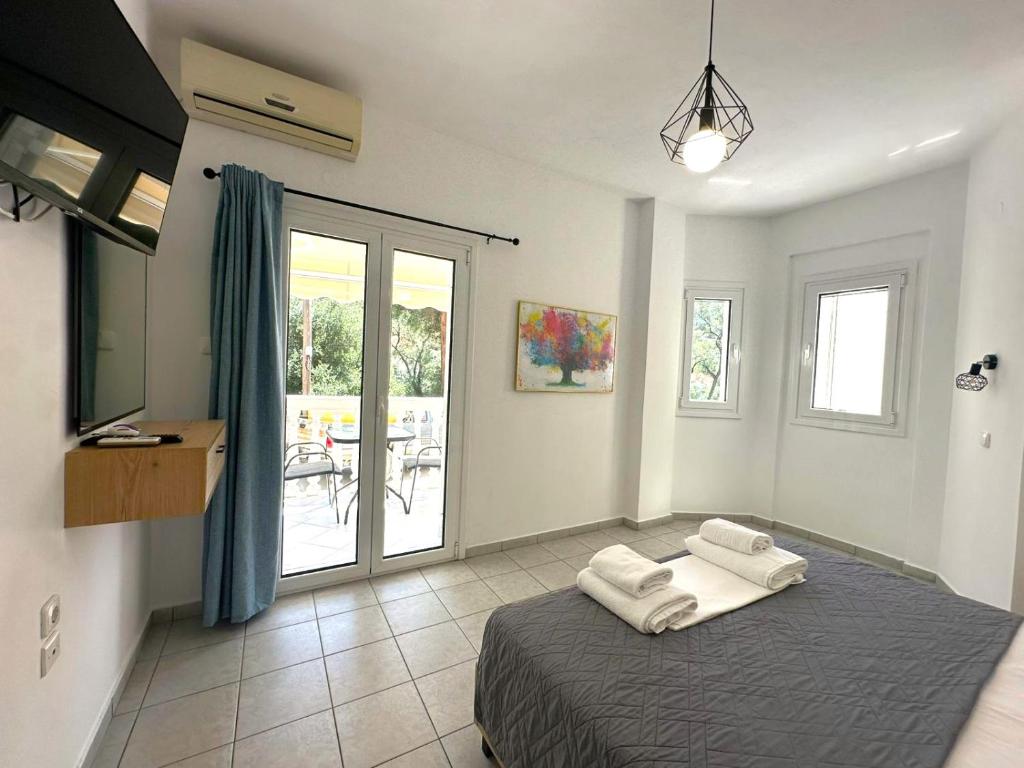 a bedroom with a bed with two towels on it at Enjoy Parga Appartments in Parga