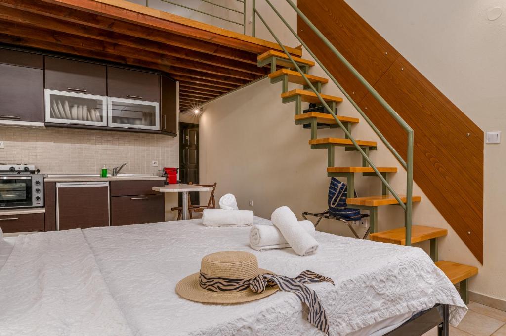 a hat on a table in a kitchen with a staircase at Kripis Studio in Pefkochori