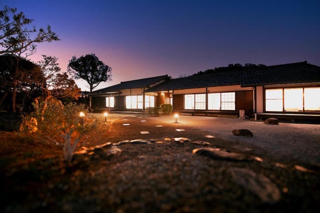 a building with lights in front of it at night at GENPEI Guest House in Takamatsu