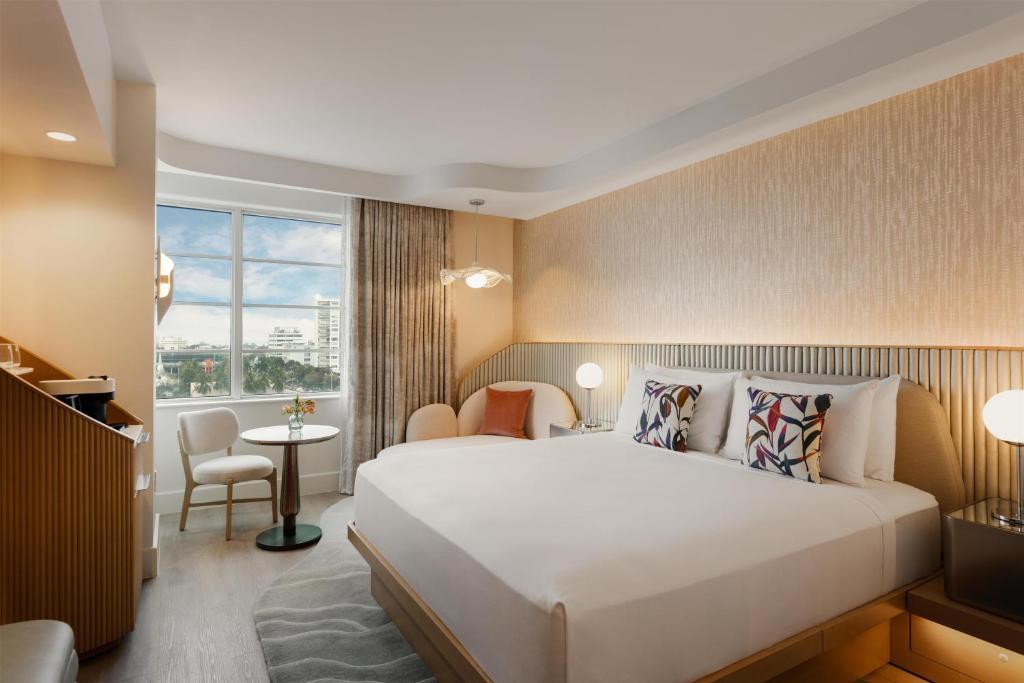 a hotel room with a large bed and a window at Andaz Miami Beach Resort & Spa in Miami Beach