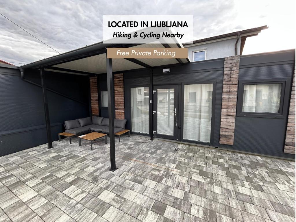a building with awning and a bench on a patio at Tiny homes ŠMARNA in Ljubljana