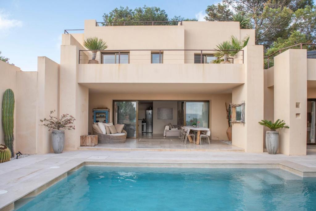 a house with a swimming pool in front of it at La Villa in Illes Balears