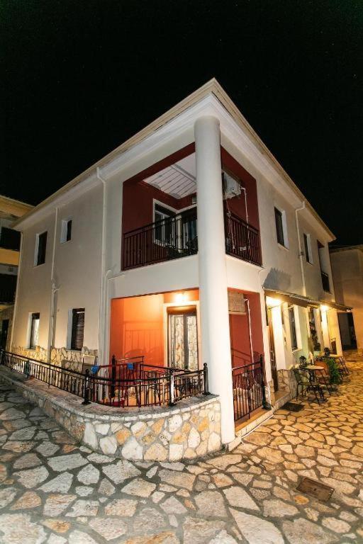 a large white building with a porch and balcony at Lina's House in Syvota