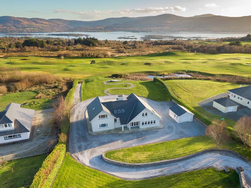an aerial view of a house on a golf course at The Iveragh in Kenmare