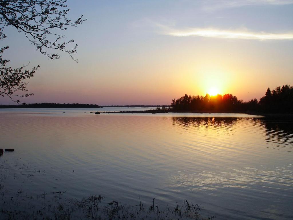 a sunset over a large body of water at Villa Sundet in Svartön