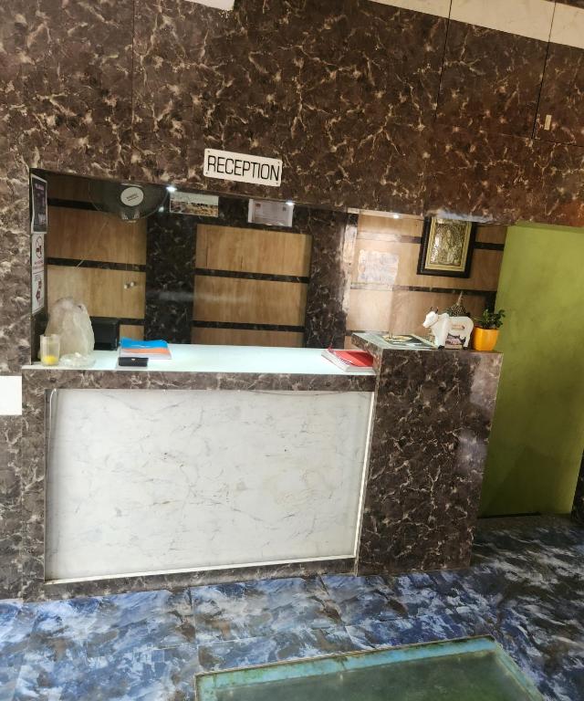 a kitchen with a counter with a sign that reads reception at SWAYAMSIDDHA continental in Kendrāparha