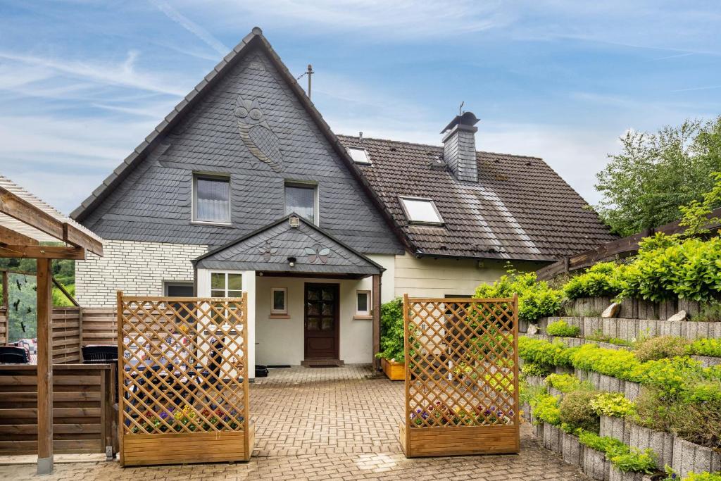a house with a gate in front of it at Ferienhaus Maag, 102qm in Attendorn