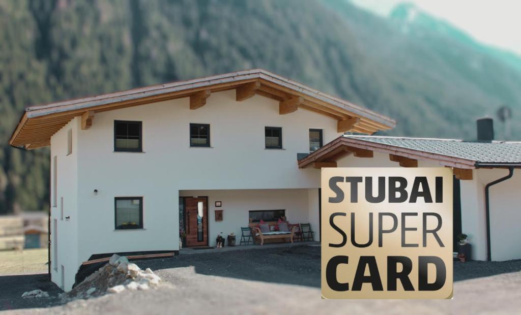 a house with a sign in front of it at Apartment VIERSTERNE in Neustift im Stubaital