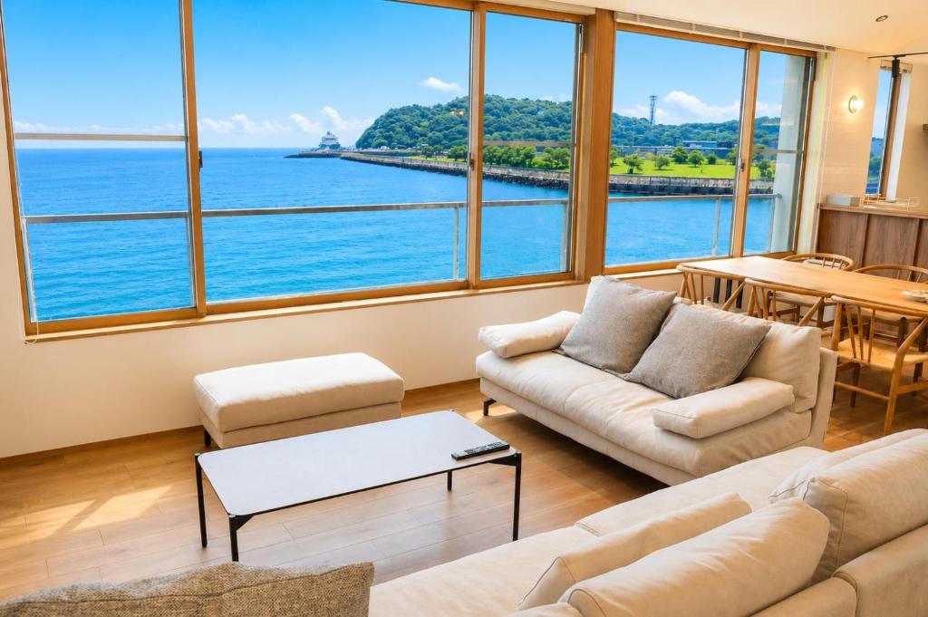 a living room with a view of the ocean at Villa JacoO 2 in Sanuki