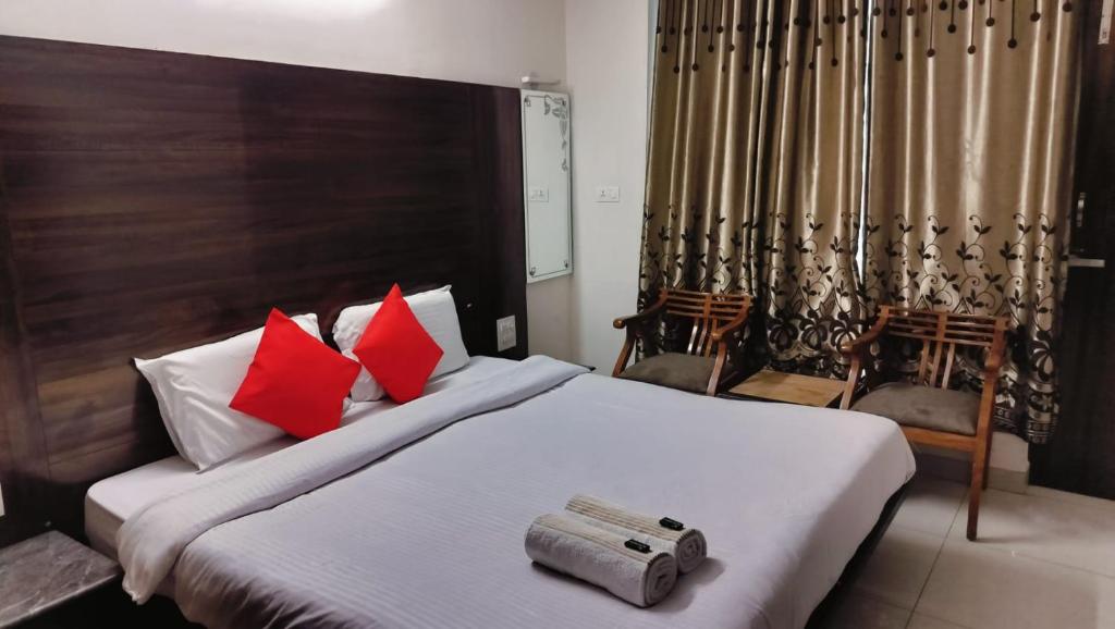a bedroom with a large bed with red pillows at Mcleodganj Mountain View Royal india-cheapest hotel in McLeod Ganj- Near Dalai Lama temple 100m-best hotel on Temple Road! in Dharamshala