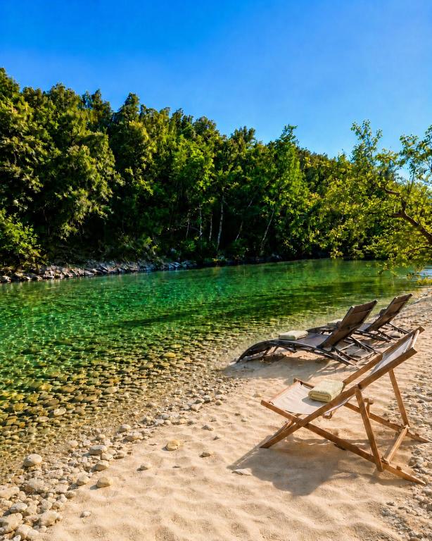 a beach chair sitting on the sand near the water at Chambres d'hôte Casprese in Altiani