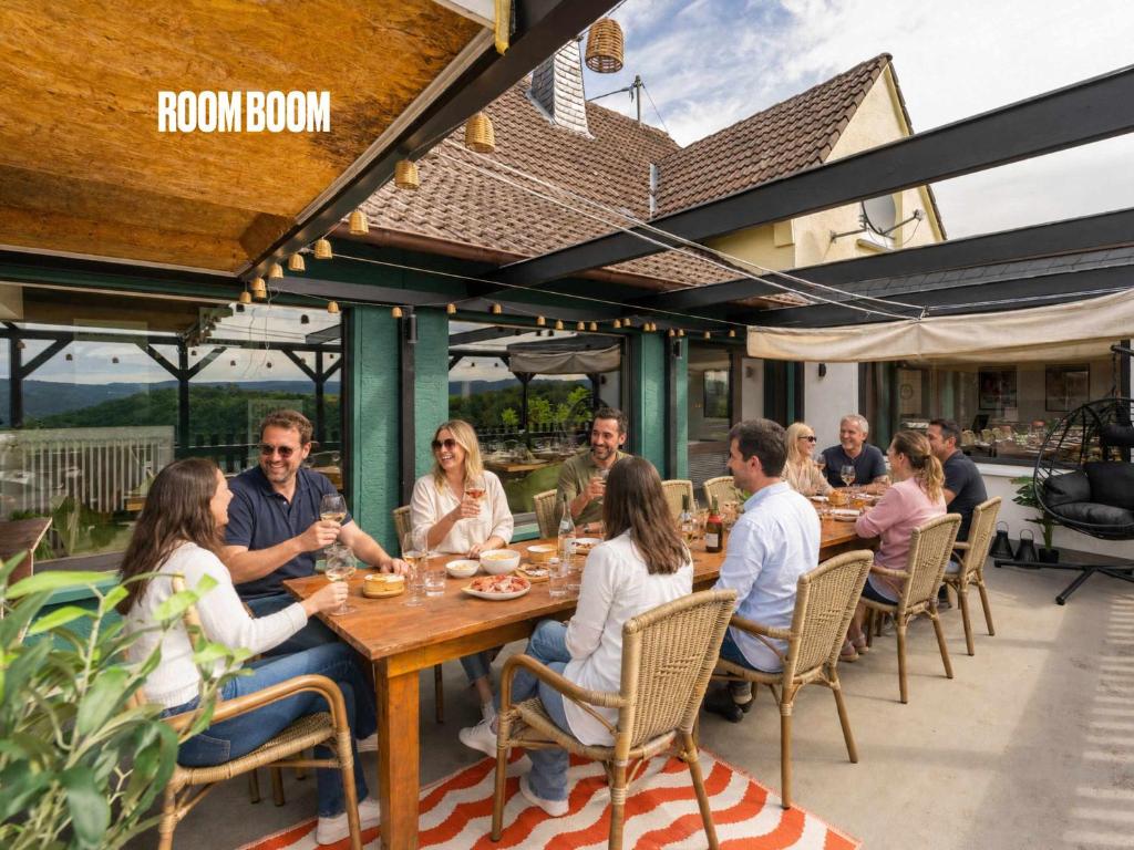 a group of people sitting at a table on a patio at The Great View Sauna & more in Harscheid