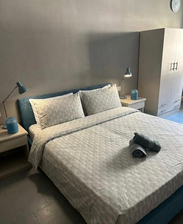 a bedroom with a large bed with two night stands at Lodge Valchiavenna in Verceia