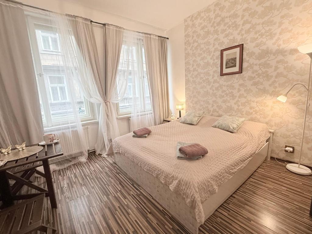 a bedroom with a bed with two pillows on it at Prague Old Town Apartment Benediktska 6 in Prague
