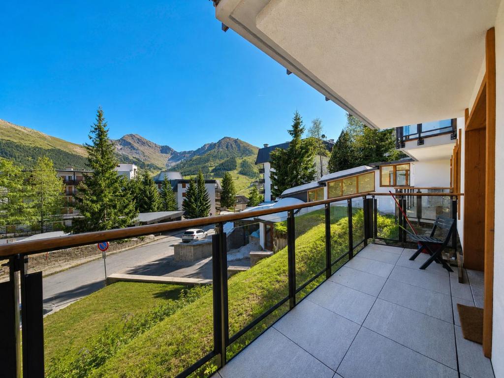 a balcony with a view of the mountains at Hostdomus - Good Vibes Apartment in Sestriere