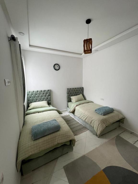 two beds sitting in a room with at Martil in Martil