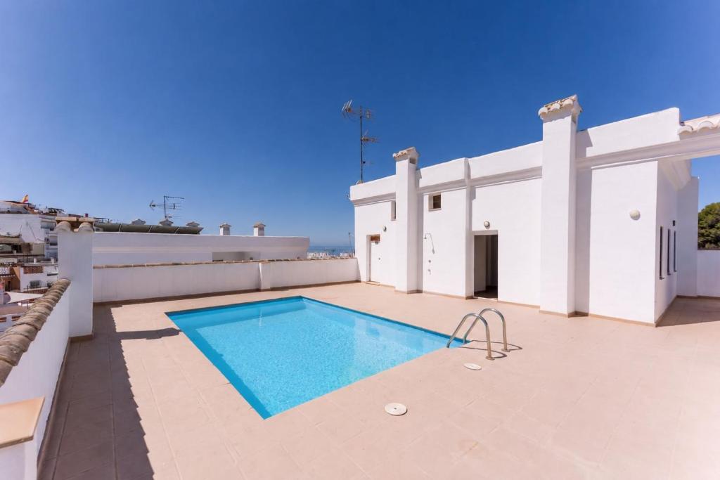 a swimming pool on the roof of a house at Rinconcito in Almuñécar