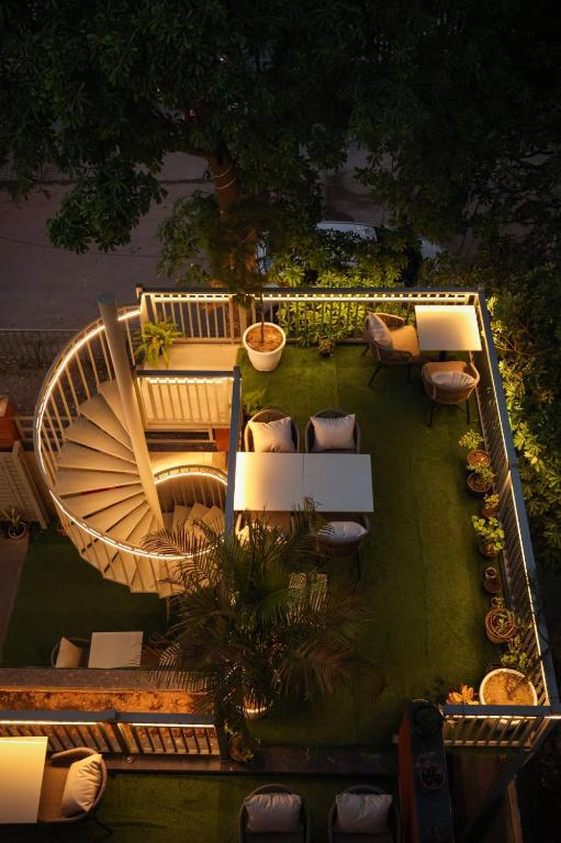 an aerial view of a garden with chairs and tables at Sandane Homes in Greater Noida