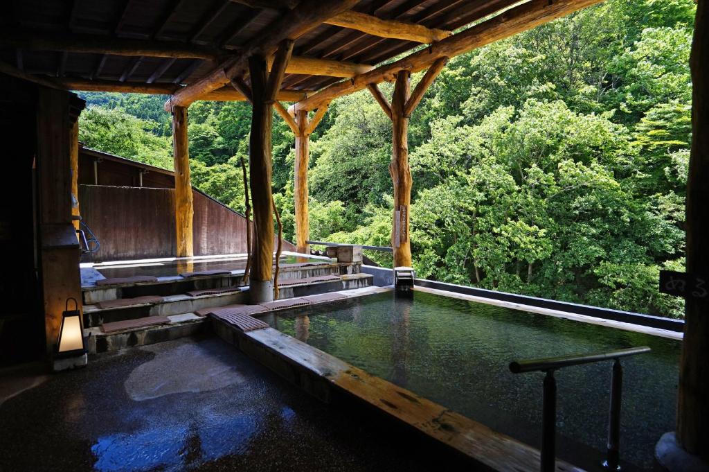 a pool of water in a building with trees at Yuze Hotel in Kazuno