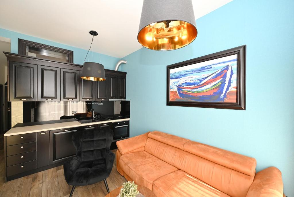 a living room with a couch and a kitchen with a counter at Casa Nuova in Kotor