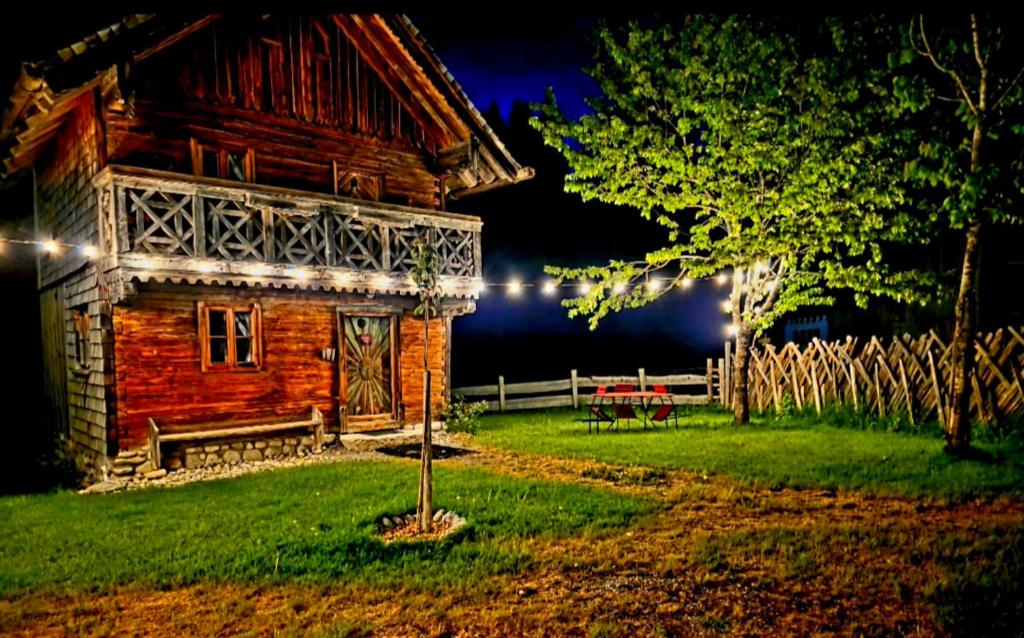 a log cabin at night with lights on it at FLICHTLHOF Hütte in Abtenau