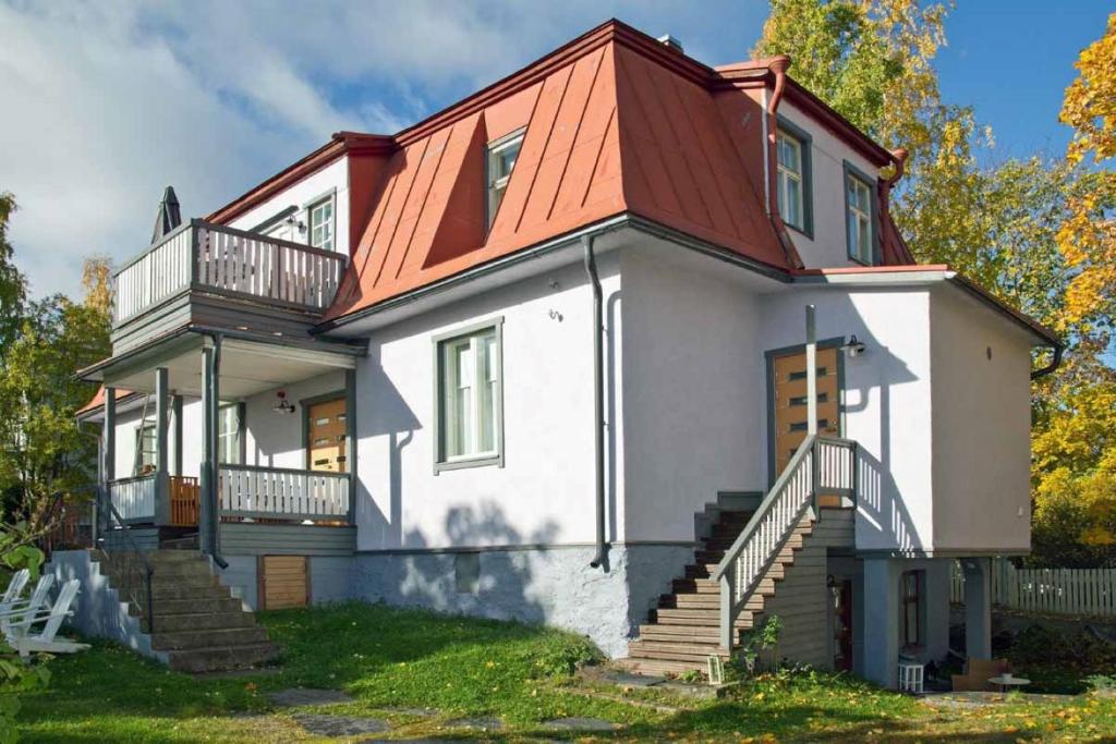 a large white house with an orange roof at Lossiranta Tavis in Savonlinna