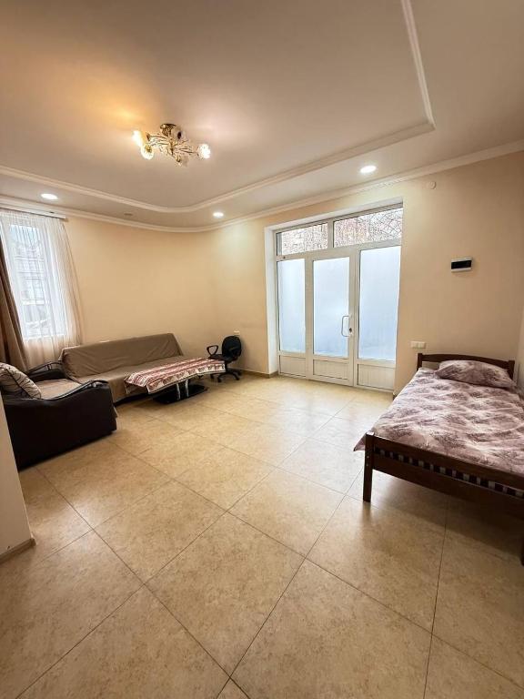a large living room with two beds and a couch at Hayrapetyan Apartment Goris in Goris