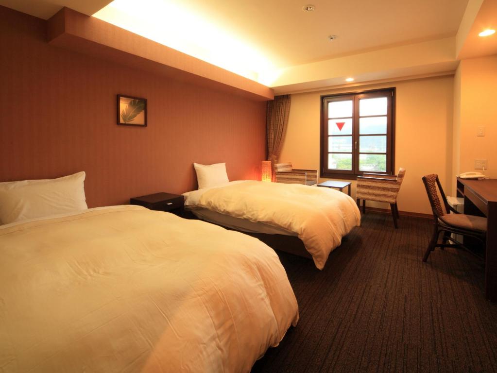 Postel nebo postele na pokoji v ubytování Nikko Station Hotel Classic