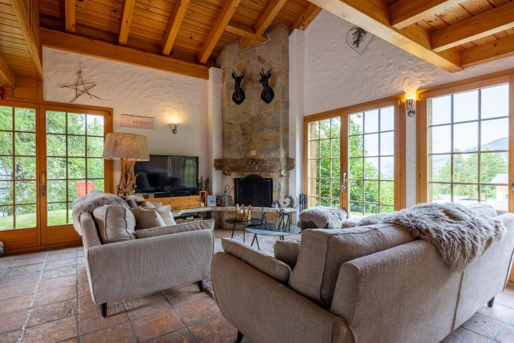 a living room with two couches and a fireplace at Chalet Pierre Blanche in Nendaz