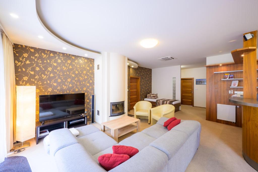 a living room with a couch and a fireplace at Apartmán Bílá Hora - Plzeň in Pilsen