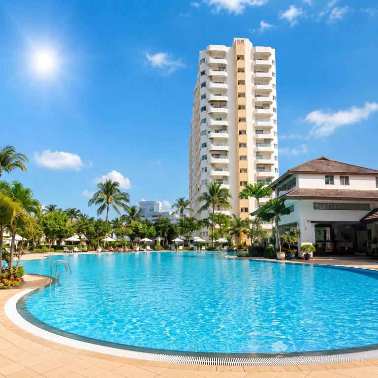 a large swimming pool with a tall building in the background at View Talay 1B Holidays in Pattaya South