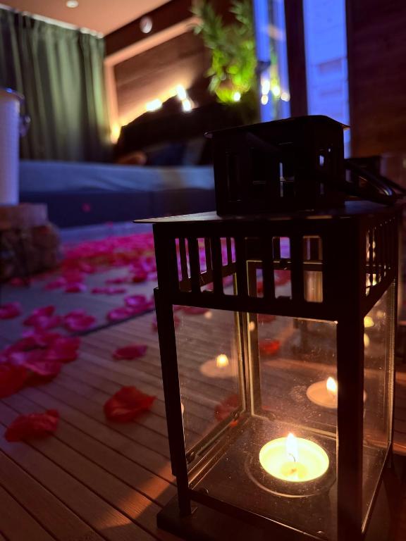 a candle in a glass box on a table at Ama Collection Esclusive Spa in Bologna