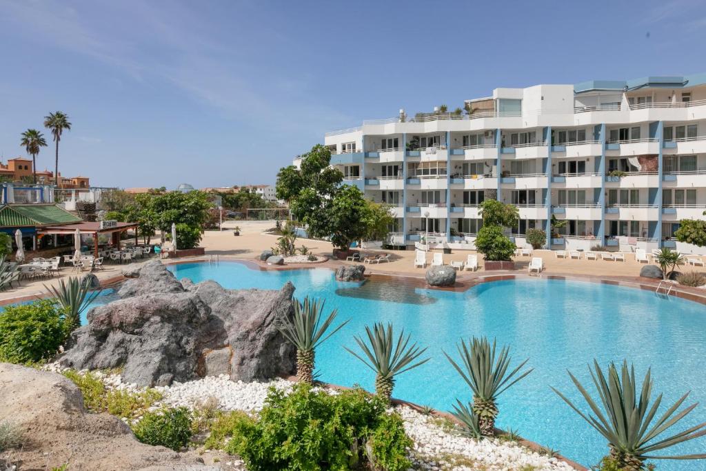 a large swimming pool in front of a hotel at Infinity Summer in San Miguel de Abona