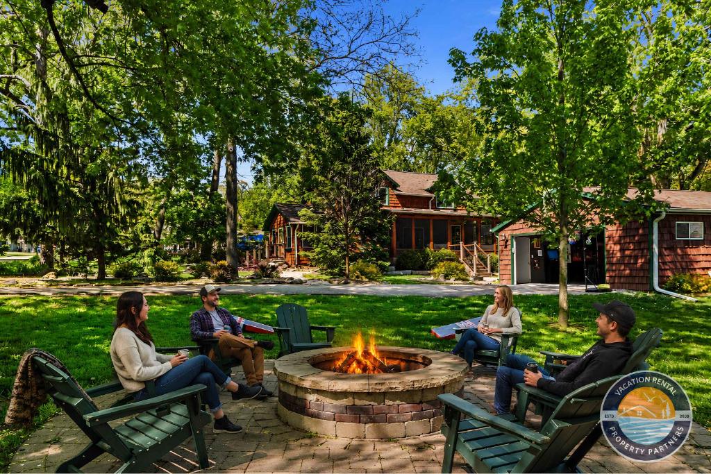 a group of people sitting around a fire pit at Peaceful Lake Como Retreat in Lake Geneva